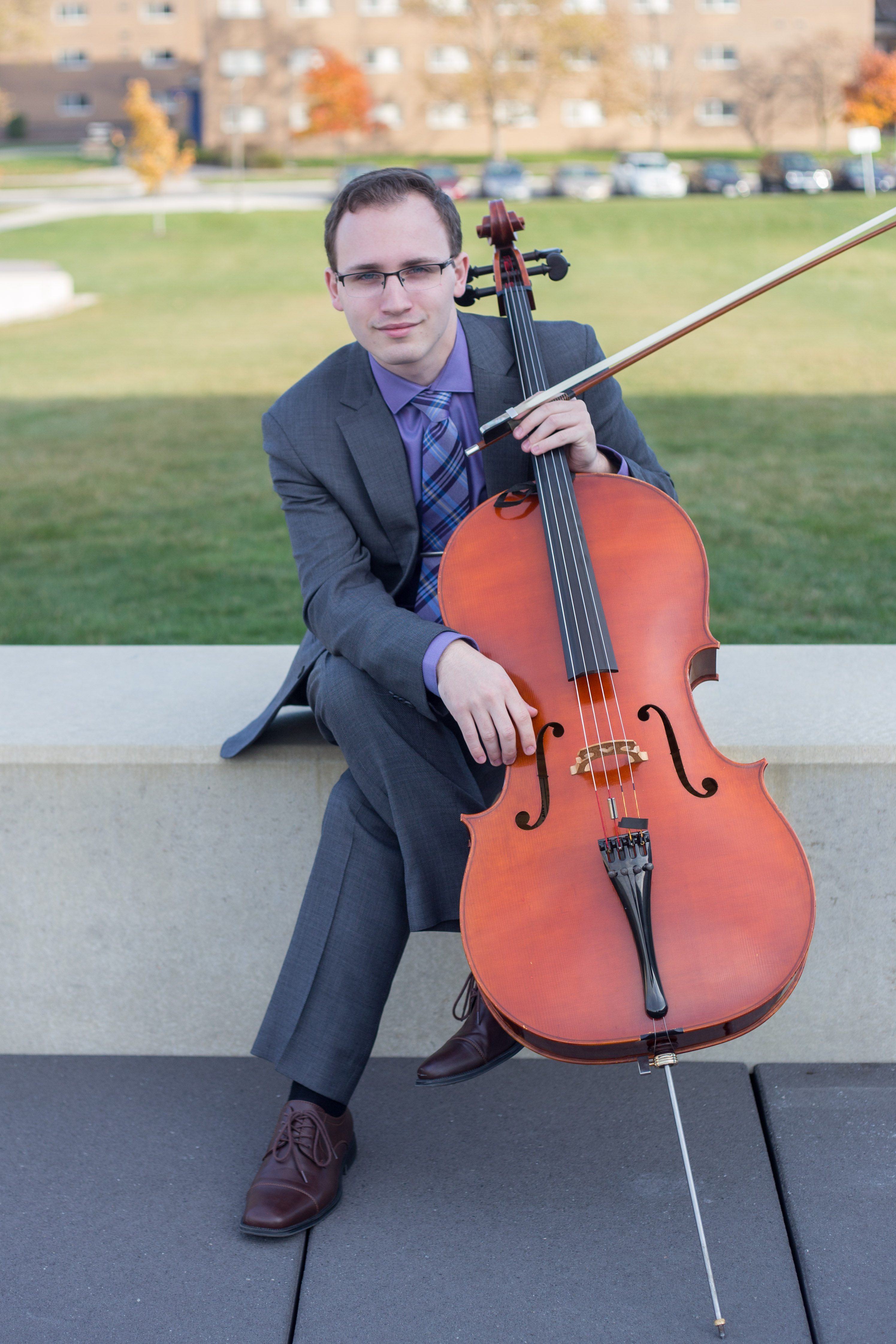 Photo of Taylor Stobinski posing with his cello